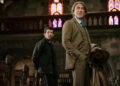 Benoit Blanc looks up inside a church in Wake Up Dead Man: A Knives Out Mystery