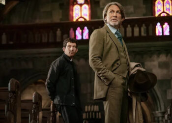 Benoit Blanc looks up inside a church in Wake Up Dead Man: A Knives Out Mystery