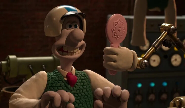 Wallace in a helmet looking at himself in a robotic mirror in Wallace & Gromit: Vengeance Most Fowl