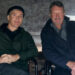 Cillian Murphy as Thomas Shelby sitting next to creator Steven Knight in a behind-the-scenes picture for Peaky Blinders