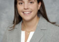 Headshot of Nyla Lewis wearing a gray suit
