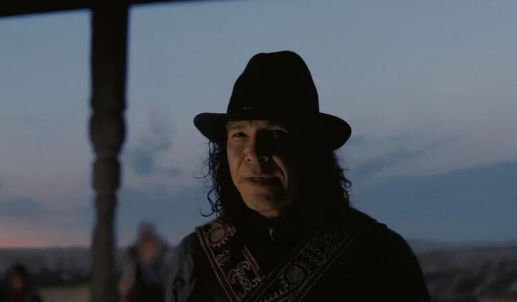 Chayton standing outside a house in Sinners