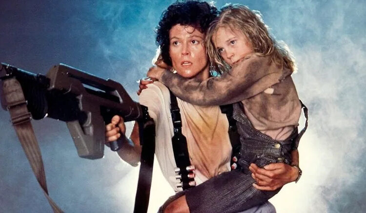 Ellen Ripley holds Newt tight while battling Xenomorphs in Aliens
