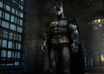 Batman standing in the halls of Arkham Asylum in Batman: Arkham Asylum