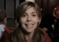 Ángela speaking to camera in hallway in [REC].