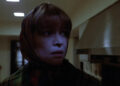 Ellen Burstyn as Chris looking nervous in her kitchen in The Exorcist