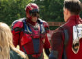 David Denman's Keith Smith wearing Captain Triumph armor while facing John Cena's Peacemaker and Jennifer Holland's Emilia Harcourt on Peacemaker