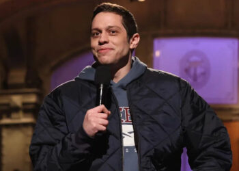 Pete Davidson holding a mic on SNL
