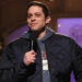 Pete Davidson holding a mic on SNL