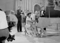 Atwell sits at a piano in a BBC studio with cameras pointed at her. Other people are also on set performing nearby