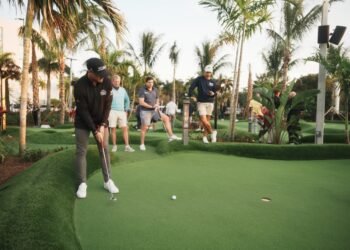 An image of a man playing mini golf.