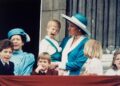 A yoing Prince Harry sits on Princess Diana's hip and sticks his tongue out on the balcony during the Platinum Jubilee.