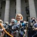Virginia Roberts Giuffre, center, who says she was trafficked by sex offender Jeffrey Epstein, holds a news conference outside a Manhattan court where sexual assault claimants invited by a judge addressed a hearing following Epstein's jailhouse death in New York, Aug. 27, 2019. (AP Photo/Bebeto Matthews, File)