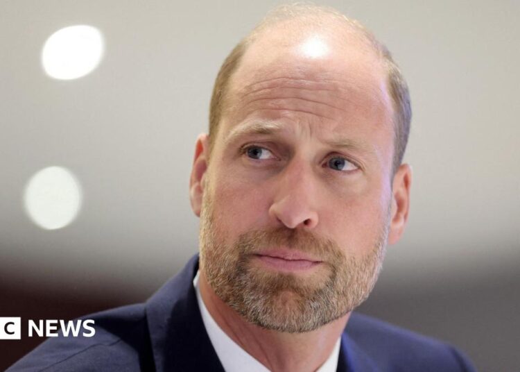 Close up shot of Prince William  in a navy suit