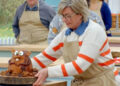 Contestant Nicky Laceby picks up her beaver cake in The Great British Bake Off