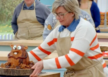 Contestant Nicky Laceby picks up her beaver cake in The Great British Bake Off