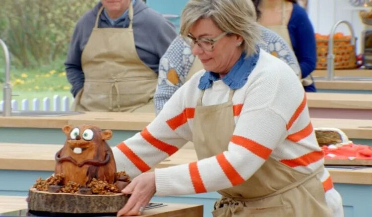 Contestant Nicky Laceby picks up her beaver cake in The Great British Bake Off