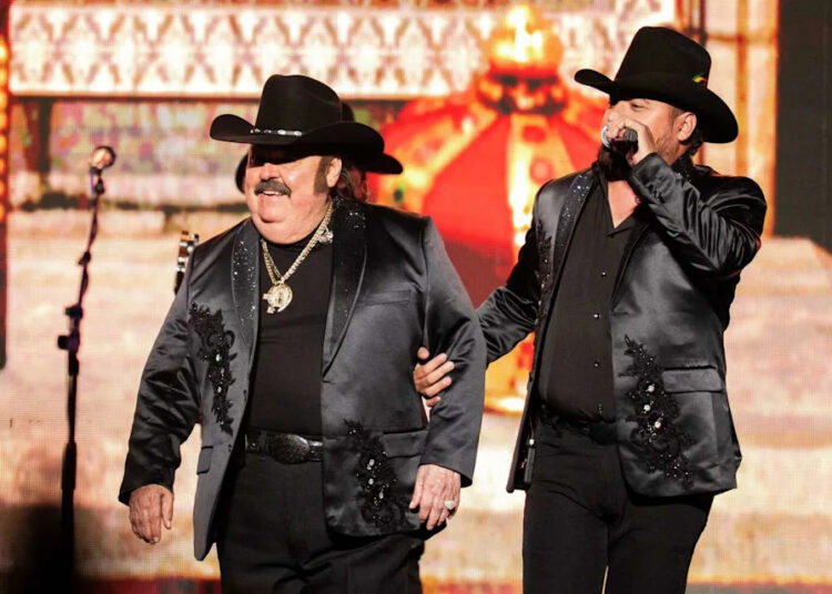 Ramon Ayala, left, walks on stage as he prepares to perform with his accordion in concert during his El Principio De Un Final tour at Toyota Center in Houston, Saturday, Oct. 11, 2025. (Jason Fochtman/Houston Chronicle)