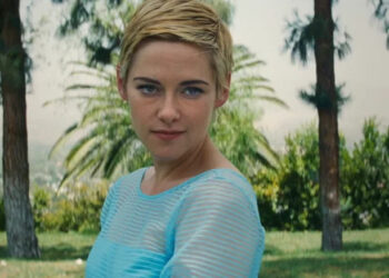Kristen Stewart's Jean Seberg is seen in closeup with palm trees in the background in Seberg