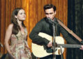 June Carter Cash and Johnny Cash singing on stage in I Walk The Line