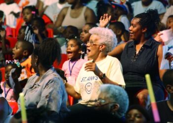 Audience members react to performers at the UniverSoul Circus during a performance in Newark, N.J., on May 12, 2004. UniverSoul Circus, a traveling one-ring circus, was founded in 1994 to bring acrobats, high-wire walkers, clowns and other performers to urban audiences. (Associated Press)