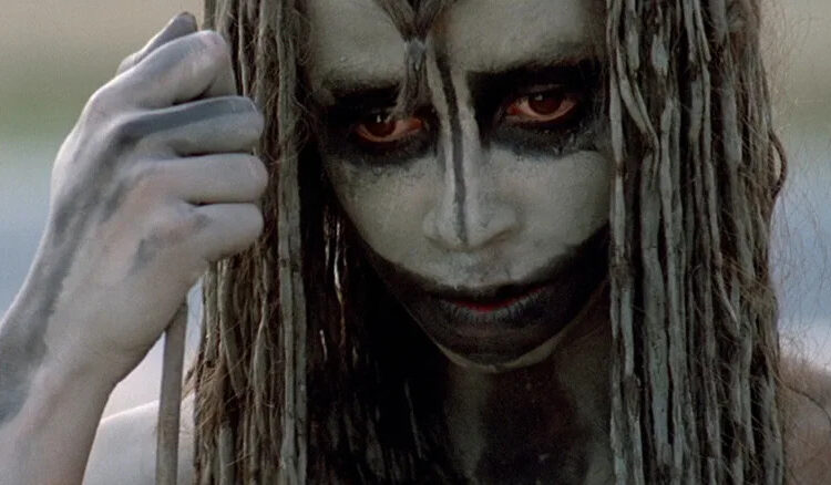 Rae Dawn Chong as Ika looking downward in Quest for Fire