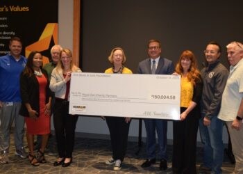 people standing with giant check
