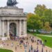 Runners run through Wellington Arch at Hyde Park Corner