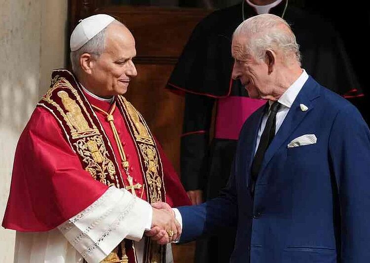 Pope Leo XIV, center, cheers with Britain's King Charles III in the St. Damasus Courtyard at the Vatican after a state visit and pray with him in the Sistine Chapel, Thursday, Oct. 23, 2025. (AP Photo/Andrew Medichini)