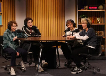 Four young women in costume as 12 year old boys recording a podcast.