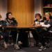 Four young women in costume as 12 year old boys recording a podcast.