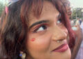 Ami Iyer, 23, wears a kiss inspired by Sabrina Carpenter's "Short and Sweet Album" as she waits for the headliner to perform Saturday. The headliner is expected to draw large crowds decked in pastels, glitter and pink as a nod to the star's style. (Lily Kepner/American-Statesman)