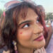 Ami Iyer, 23, wears a kiss inspired by Sabrina Carpenter's "Short and Sweet Album" as she waits for the headliner to perform Saturday. The headliner is expected to draw large crowds decked in pastels, glitter and pink as a nod to the star's style. (Lily Kepner/American-Statesman)