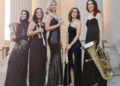 The Seraph Brass ensemble includes Mary Elizabeth Bowden, trumpet; Morgen Low, trumpet; Layan Atieh, horn; Lauren Casey-Clyde, trombone; and Robyn Black, tuba. The women, all wearing long brass dresses and holding their instruments, stand fr a group photo. (Courtesy photo)