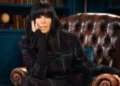 BBC Claudia Winkleman sitting in an armchair in the Traitors castle in Scotland