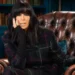 BBC Claudia Winkleman sitting in an armchair in the Traitors castle in Scotland