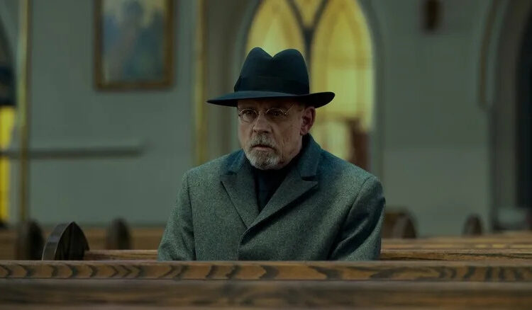 Pym sitting in a church pew in The Fall of the House of Usher