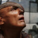Dennis Hopper as Deacon staring up in disbelief in Waterworld