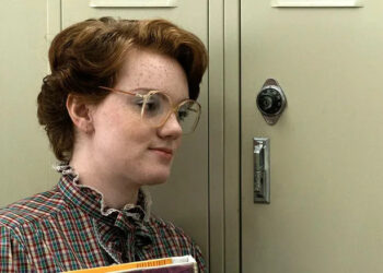 Shannon Purser as Barb standing in front of her locker in Stranger Things season 1