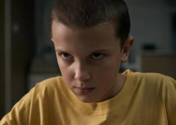 Eleven wearing a yellow t-shirt on Stranger Things