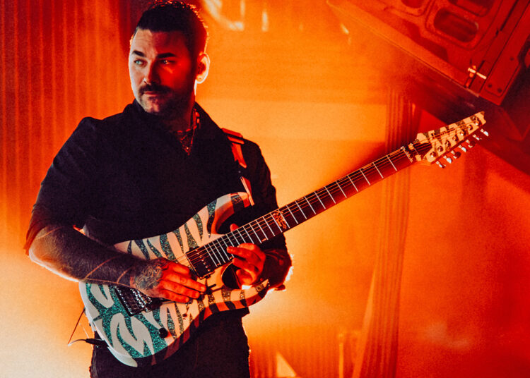 Lorna Shore’s Adam De Micco with one of his Ibanez custom guitars
