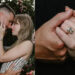 A couple embracing outdoors; the woman shows an engagement ring on her hand.