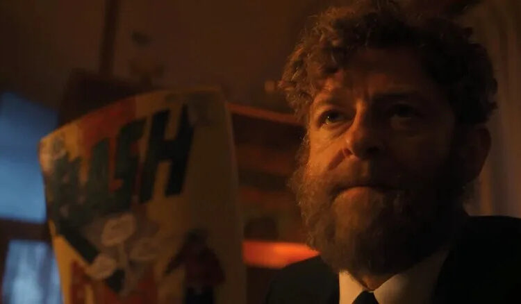 Rabbi Uris holding the Flash #123 comic in It: Welcome to Derry
