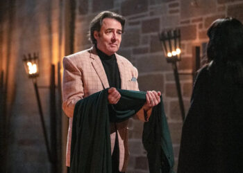 Jonathan Ross accepts the traitors cloak from Claudia Winkleman. (BBC/Studio Lambert/Euan Cherry)