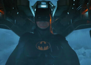 Michael Keaton's Batman sits in a plane in The Flash