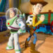 Two animated characters, a cowboy and a space ranger, stand back-to-back with confident poses in a colorful room