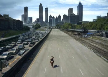 Rick on horseback traveling down an empty highway in The Walking Dead