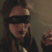 A masked woman smoking a cigarette in 50 Kisses