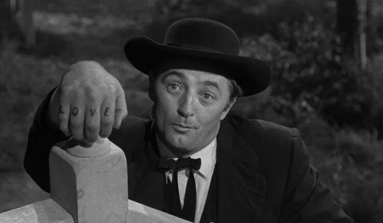 Harry Powell shows off his tattoos in The Night of the Hunter