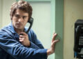 Zac Efron as Ted Bundy holding a phone to his ear in Extremely Wicked, Shockingly Evil and Vile